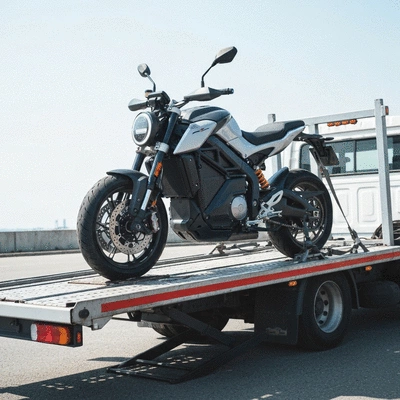 Modern electric motorcycle being loaded onto a specialized transport lift